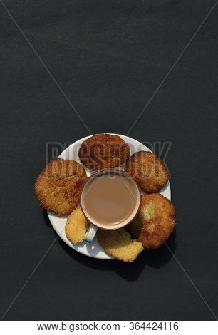 Top View Of Tea Cup And Homemade Semolina Cookies In A Plate Isolated On Black Background With Copy 