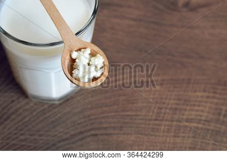 Kefir Grains In Wooden Spoon And Kefir Drink In Glass