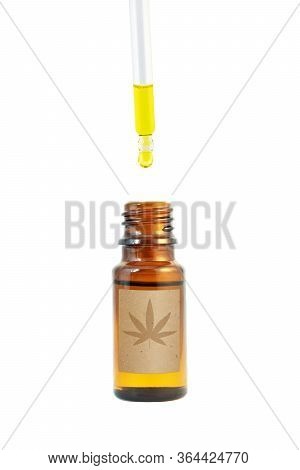 Cannabidiol Oil In The Dark Amber Glass Bottle And Dropper Isolated On White. Сannabis Leaf Silhouet