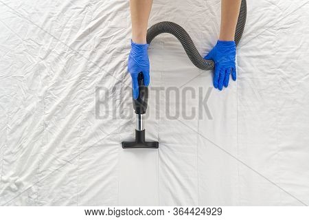 Vacuuming Bed. Domestic Home Cleaning Concept. Textile Sofa Chemical Cleaning. Upholstered Furniture