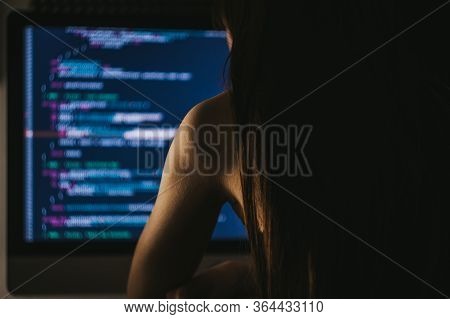 Young Female Programmer Writes Program Code On A Computer. Home Office