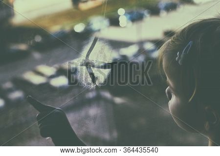 Girl Looks Lonely Through Window By Putting Her Hands On Window Sill