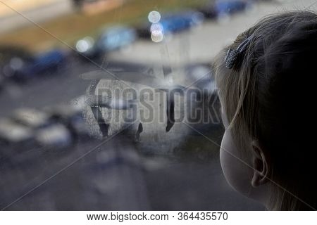 Girl Looks Lonely Through Window By Putting Her Hands On Window Sill