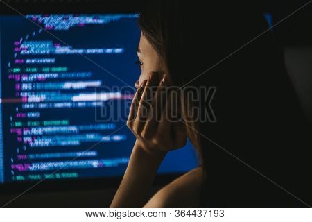 Young Female Programmer Writes Program Code On A Computer. Home Office