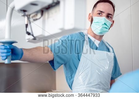Internal specialist doctor during endoscopy procedure in a hospital adjusting screen