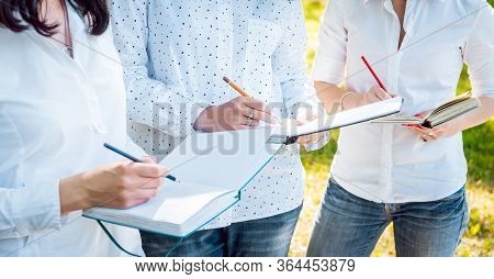 Young Beautiful Girls Drawing The Pictures In Sketchbook.