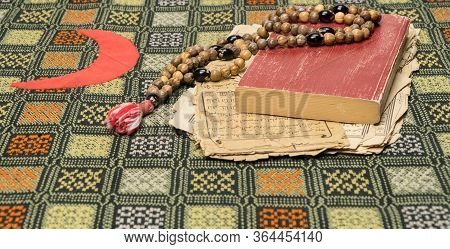 Tashkent, Uzbekistan - April 26, 2020: Muslim Prayer Beads With Quran And With Sheets With Ancient A