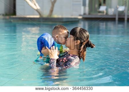 Asian Family, Beautiful Mother And Cute Baby Boy Happinese In Swimming Pool, At Luxury Resort.