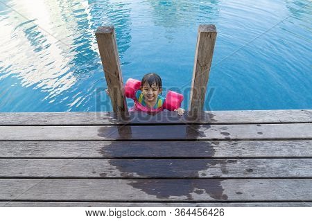 Asian Cute Girl Happinese In Swimming Pool, At Luxury Resort.