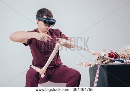 Doctor Uses Augmented Reality Goggles To Exam Human Skeleton.