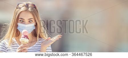 Beautiful Girl Wearing A Face Mask Looking Down At An Ice Cream In Her Hand With A Cross-eyed Look A