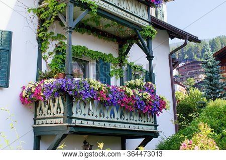 Traditional Tirol House Balcony Decorated With Varieties Of Petunia And Surfinia Flowers, Dolomites 