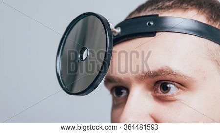 Medical Frontal Reflector On The Doctors Head