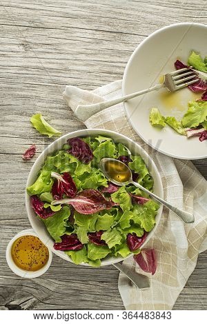 Healthy Red And Green Lettuce Salad Meal On Wooden Table Background. Eating Fresh Radicchio And Youn