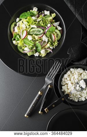 Healthy Green Salad With Fresh Vegetables And Fresh Cheese On Black Background Close Up