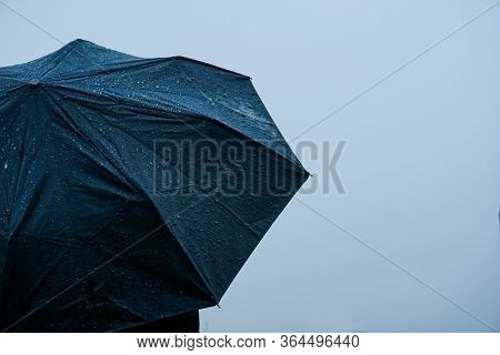 Alone Man Standing Out In Rain With An Umbrella