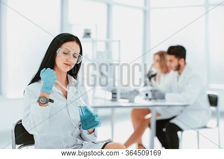 Close Up.woman Scientist Takes A Sample Of The Liquid .