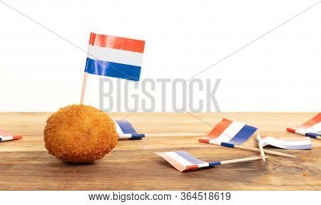 Dutch Traditional Snack Bitterbal, Just One Left On A Wooden Serving Board, Isolated