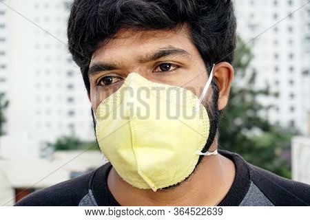 Indian Man In Yellow Protective Face Mask