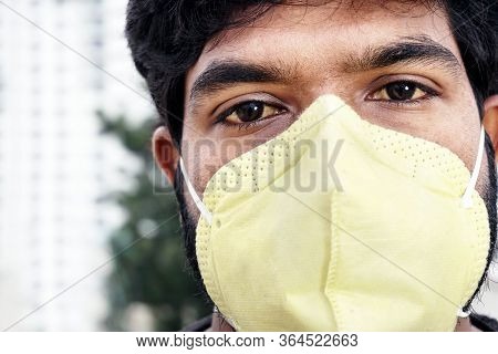Indian Man In Yellow Protective Face Mask