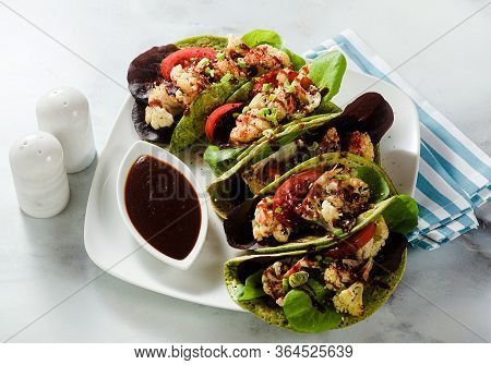 Gluten-free Vegan Green Tachos Made From Chickpea Flour With Spinach And Toppings From Baked Caulifl