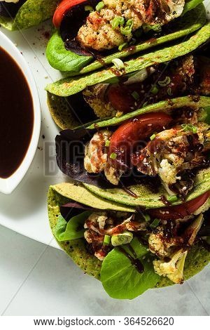 Gluten-free Vegan Green Tachos Made From Chickpea Flour With Spinach And Toppings From Baked Caulifl