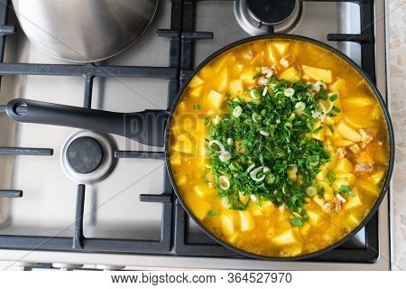 Stewed Potatoes With Meat In A Frying Pan On The Stove Close Up