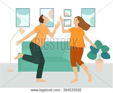 A Couple Of Young People Are Dancing In The Living Room. A Man And A Woman Spend Fun Time Together A