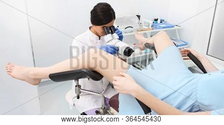 Women Having A Cervix Exam By Her Gynecologist, Lying On A Gynecological Chair. Colposcopy, Diagnosi
