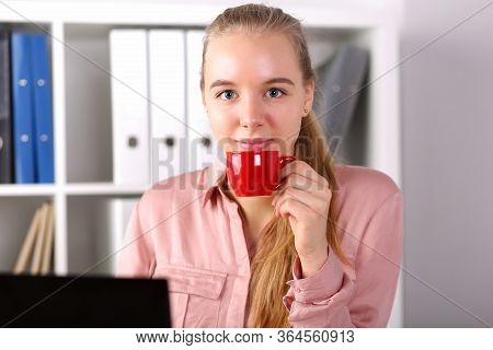 Girl Sits Office Front Computer And Drinks Coffee. Chosen Profession Is Overloaded With High Competi