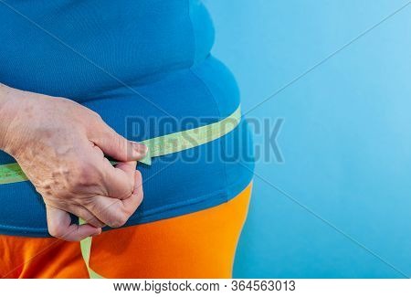 Measure The Waist With A Centimeter Tape. The Problem Of Excess Weight. Full Belly And Folds. Hands 