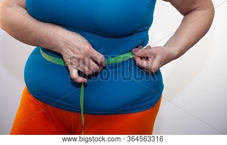Measure The Waist With A Centimeter Tape. The Problem Of Excess Weight. Full Belly And Folds. Hands 