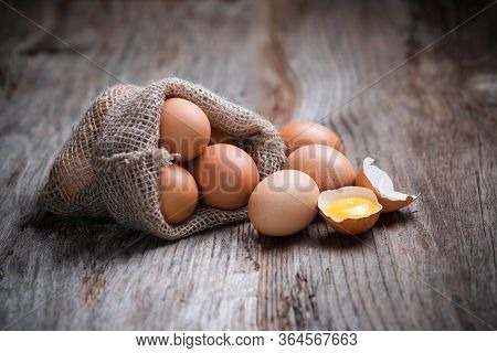 Eggs In A Little Sack On A Wooden Table.