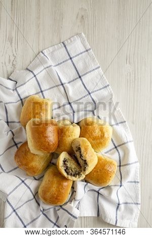 Home-baked Beef Russian Bierocks On A White Wooden Table, Top View. Flat Lay, Overhead, From Above. 