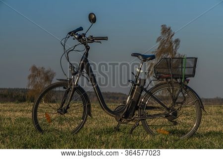 Black Electric Bike On Ski Slope In Budweis City With Windy Trees