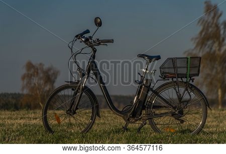 Black Electric Bike On Ski Slope In Budweis City With Windy Trees