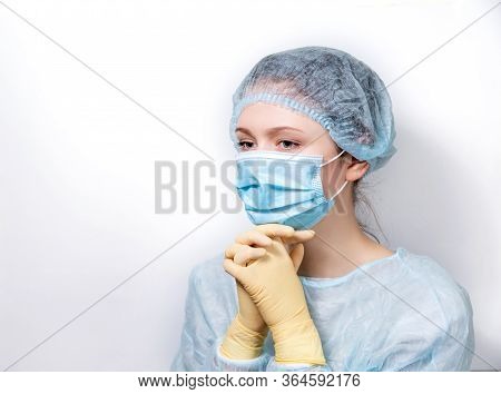A Young Doctor In Medical Dress Clasped Her Hands In Prayer. It Asks To Save The World, The Planet, 
