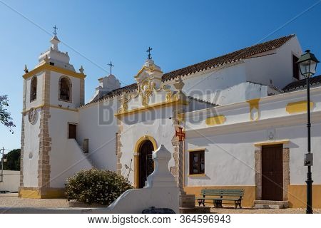 Side Of Igreja Matriz De Alvor - Church In A Portuguese City. White Facade With Yellow Details. Brig