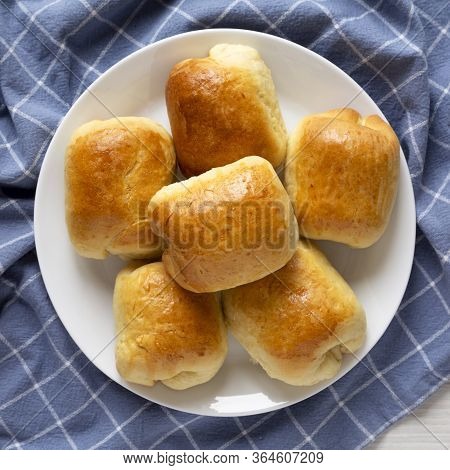 Home-baked Beef Russian Bierocks On A White Plate On Cloth, Overhead View. Flat Lay, Top View, From 