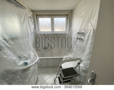 Covered Bathroom Walls With Tarp And Ladder In Preparation For Painting