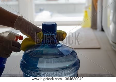 The Woman Disinfects The Carboy In The Kitchen To Protect It From Coronavirus.