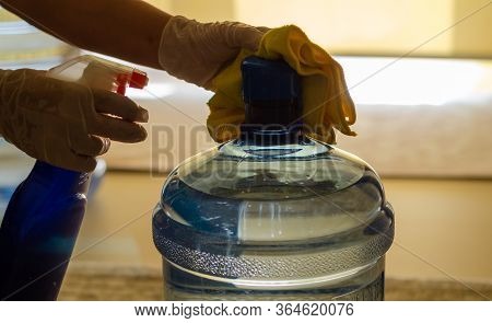 The Woman Disinfects The Carboy In The Kitchen To Protect It From Coronavirus.