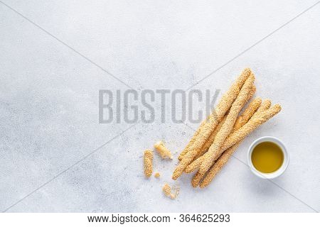 Organic Italian grissini or salted bread sticks and bread lying on a gray background. Fresh Italian 