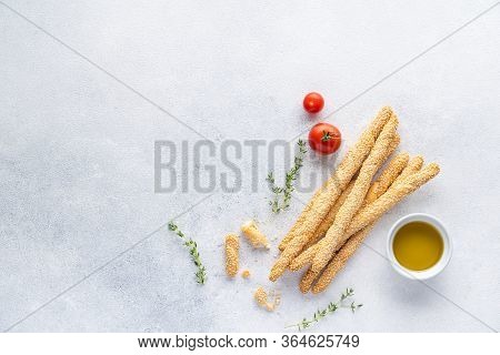 Organic Italian Grissini Or Salted Bread Sticks And Bread Lying On A Gray Background. Fresh Italian 