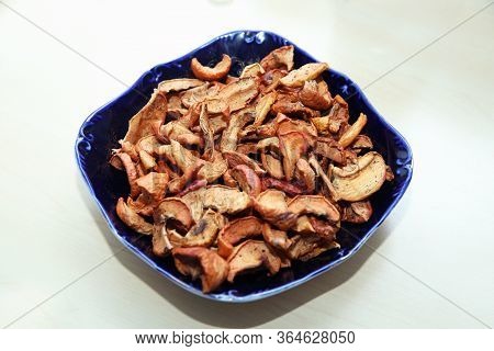 Dried Apple Slices In Woodenl Blue Plate Isolated On White . Dehydrated Apples Chips On Plate, Top V
