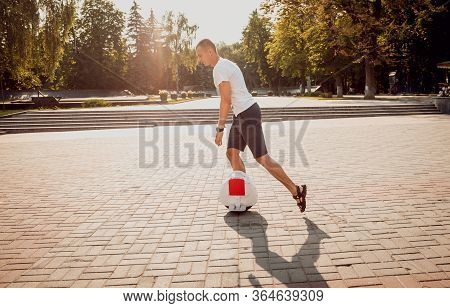 Young Man Driving On Solowheel In The Park.