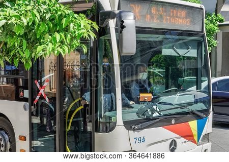 Thessaloniki, Greece - May 4 2020: Public Bus Driver Wearing Covid-19 Protective Mask. Oasth Public 