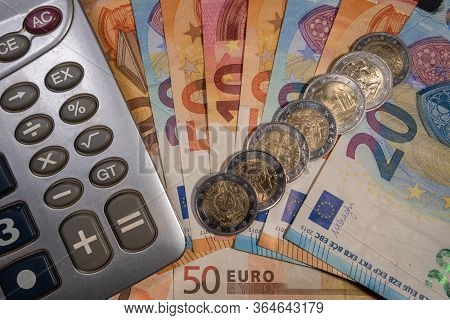 Many Scattered Eruos Bills And Coins And Calculator