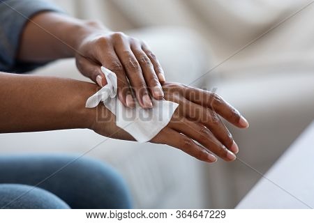 Antibacterial Wipes. African American Woman Disinfecting Hands With Wet Tissues At Home, Closeup