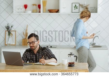 Boyfriend And Girlfriend Working At Home At The Kitchen During Pandenic